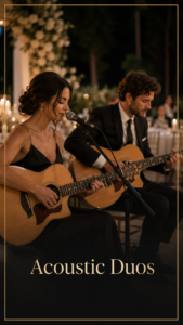 Two musicians—a woman singing into a microphone and a man playing an acoustic guitar—performing at a nighttime outdoor event with warm candlelight. The scene emphasizes a live acoustic duo.